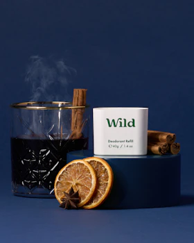 Caption: a cup of tea next to an orange slice