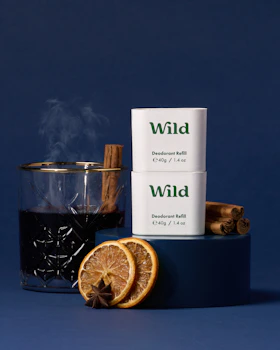 Caption: a cup of tea next to a container of wild