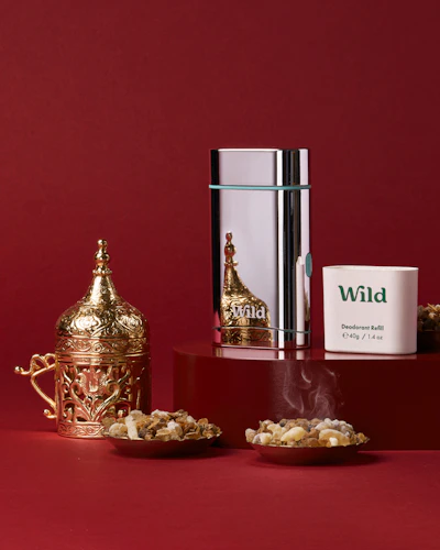 Caption: a red table topped with a cup of coffee next to a container of popcorn