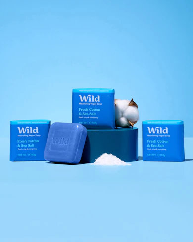 Caption: three soaps and a bar of soap on a blue background
