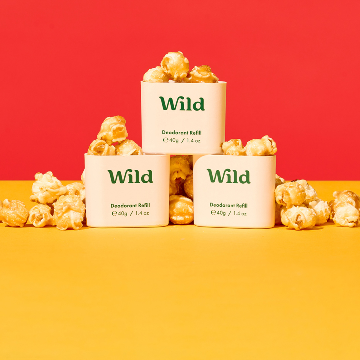 Caption: three white containers filled with popcorn sitting on top of a yellow table