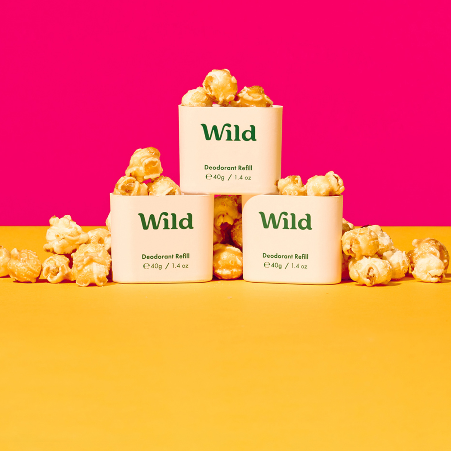 Caption: three white containers filled with popcorn sitting on top of a yellow table