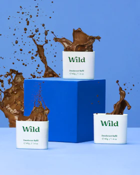 Caption: three cups of chocolate milk splashing out of them