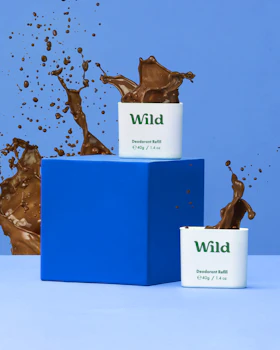 Caption: a couple of cups of chocolate are in front of a blue box