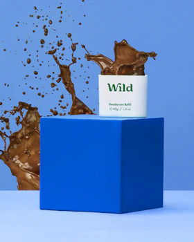 Caption: a can of wild on top of a blue block