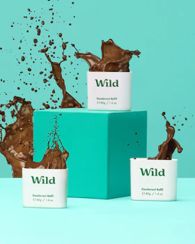 Caption: three cups of chocolate milk splashing out of them