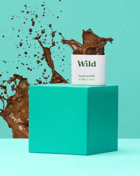 Caption: a bottle of wild on top of a green box
