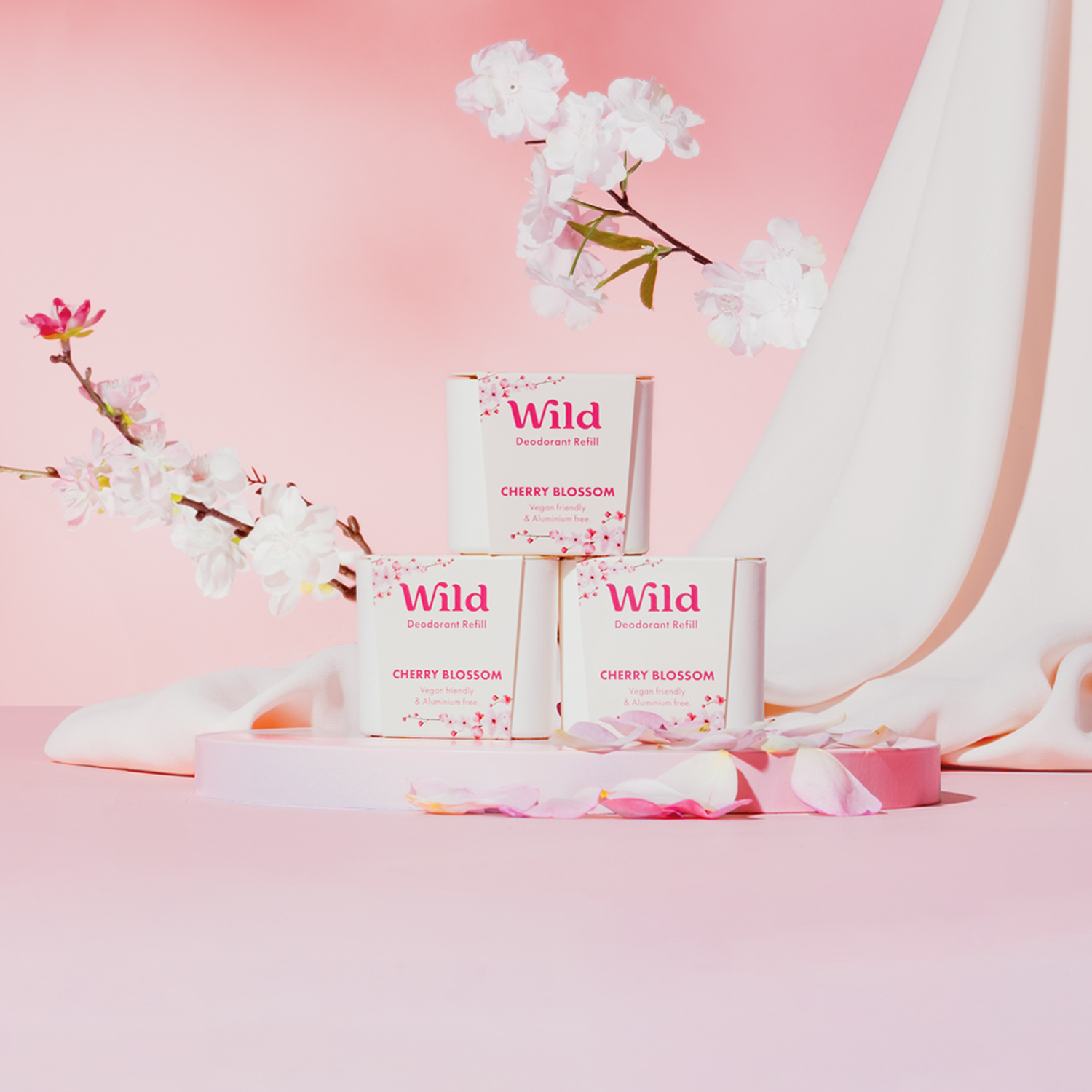 Caption: a pink background with white flowers and three boxes