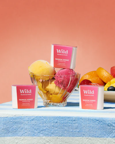 Caption: a table topped with bowls of fruit and a bowl of ice cream