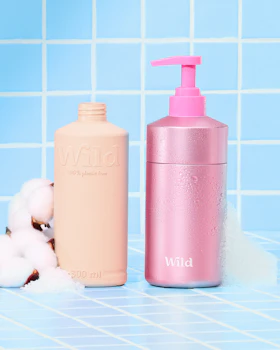 Caption: a bottle of lotion next to a bottle of soap