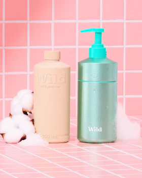Caption: a bottle of soap next to a bottle of lotion