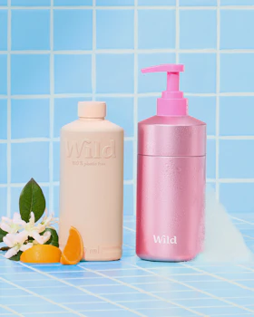 Caption: a bottle of lotion and a bottle of body lotion on a blue tiled