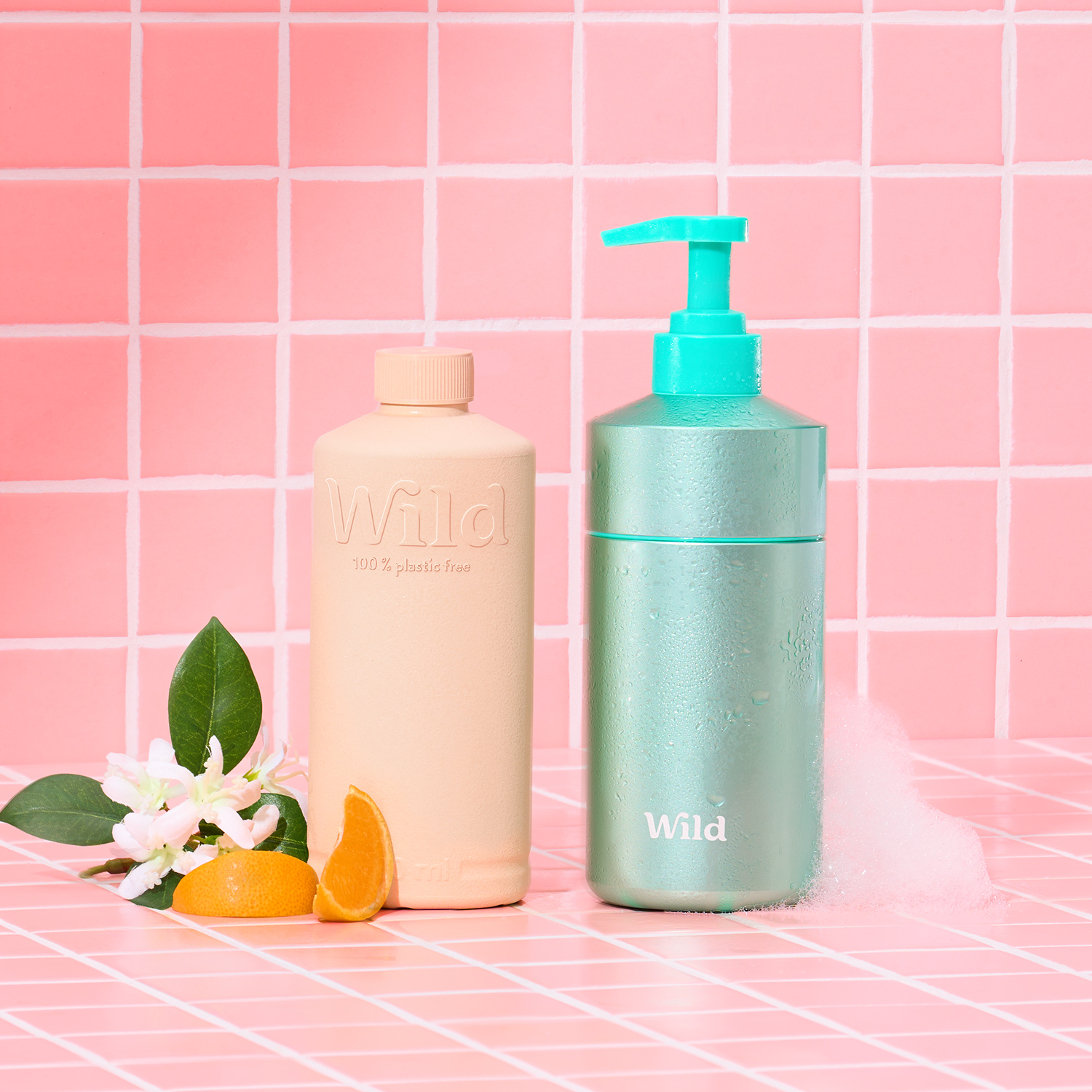 Caption: a bottle of lotion next to an orange and a soap dispenser