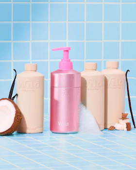 Caption: a bottle of lotion, a bottle of lotion and a coconut on a