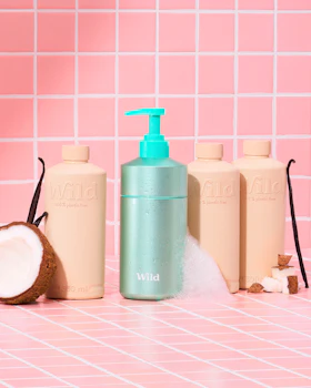 Caption: a bottle of lotion, a coconut, and a bottle of lotion on