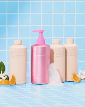 Caption: a bottle of lotion next to three bottles of lotion