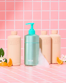 Caption: a bottle of lotion next to three bottles of lotion
