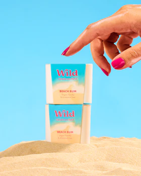 Caption: a woman's hand reaching for a stick of wild deodorant
