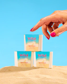 Caption: a woman's hand reaching for three soap bars