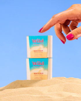 Caption: a woman's hand reaching for a tube of deodorant