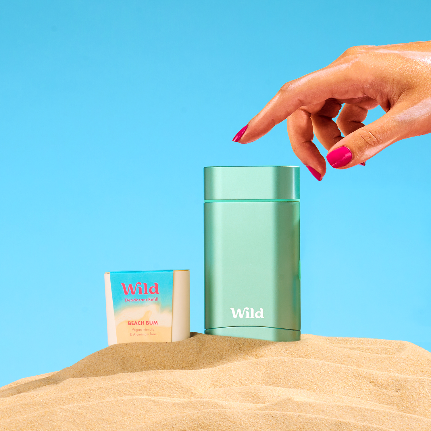 Caption: a woman's hand reaching for a bottle of wild