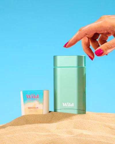 Caption: a woman's hand reaching for a bottle of wild