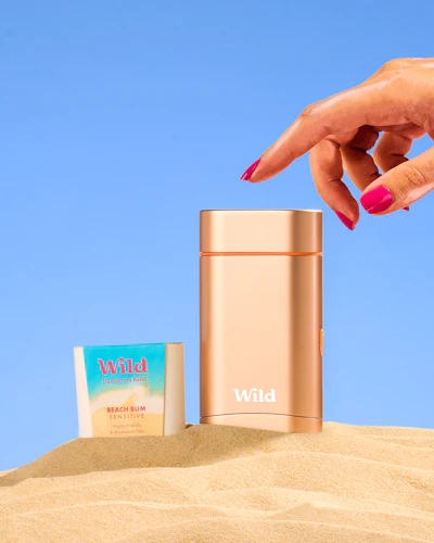 Caption: a woman's hand reaching for a bottle of wild