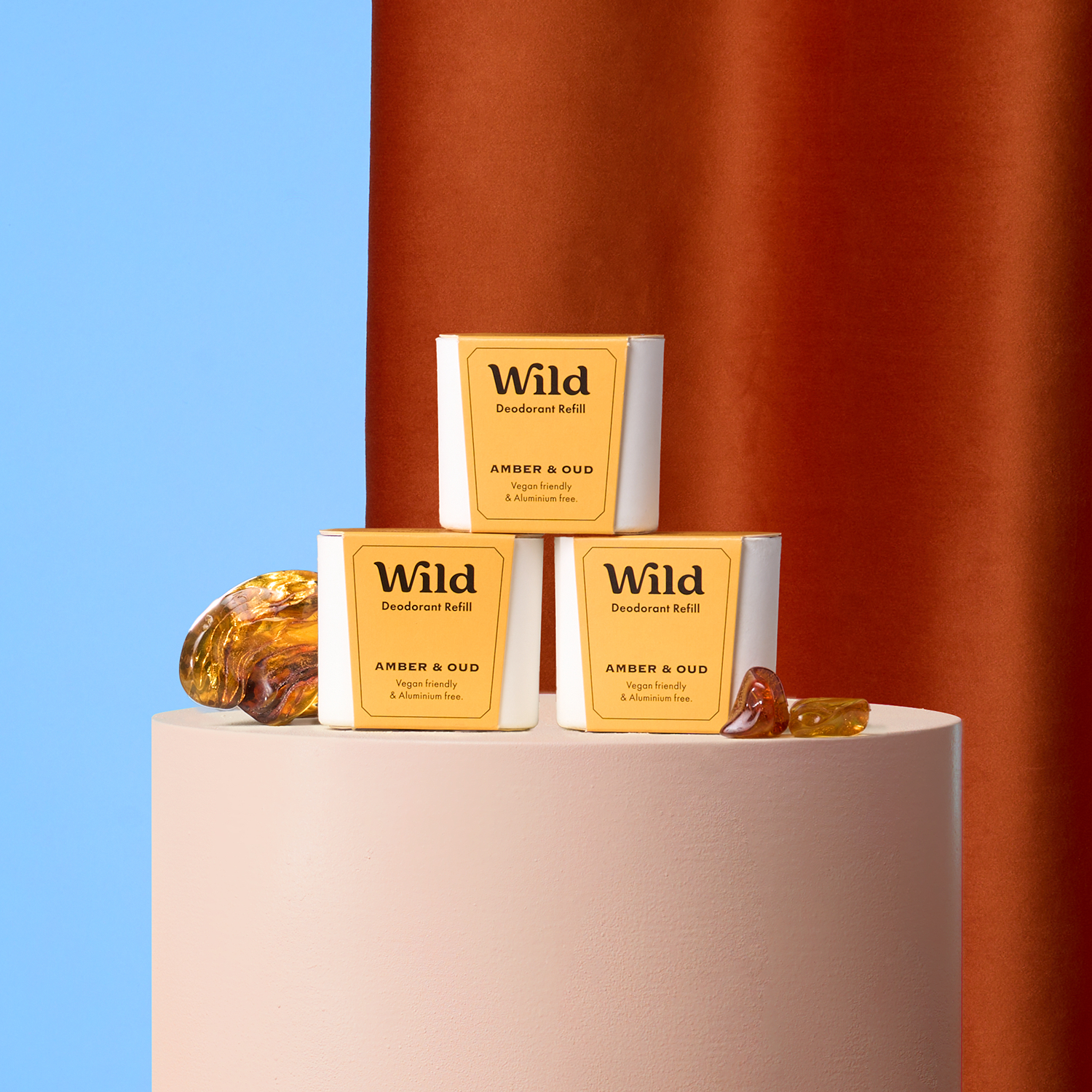 Caption: three bars of soap sitting on top of a white stand