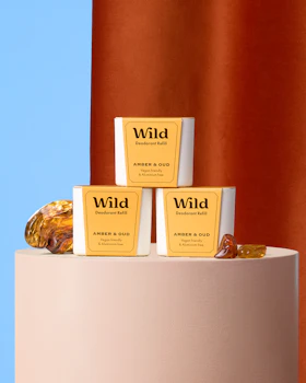 Caption: three bars of soap sitting on top of a white stand