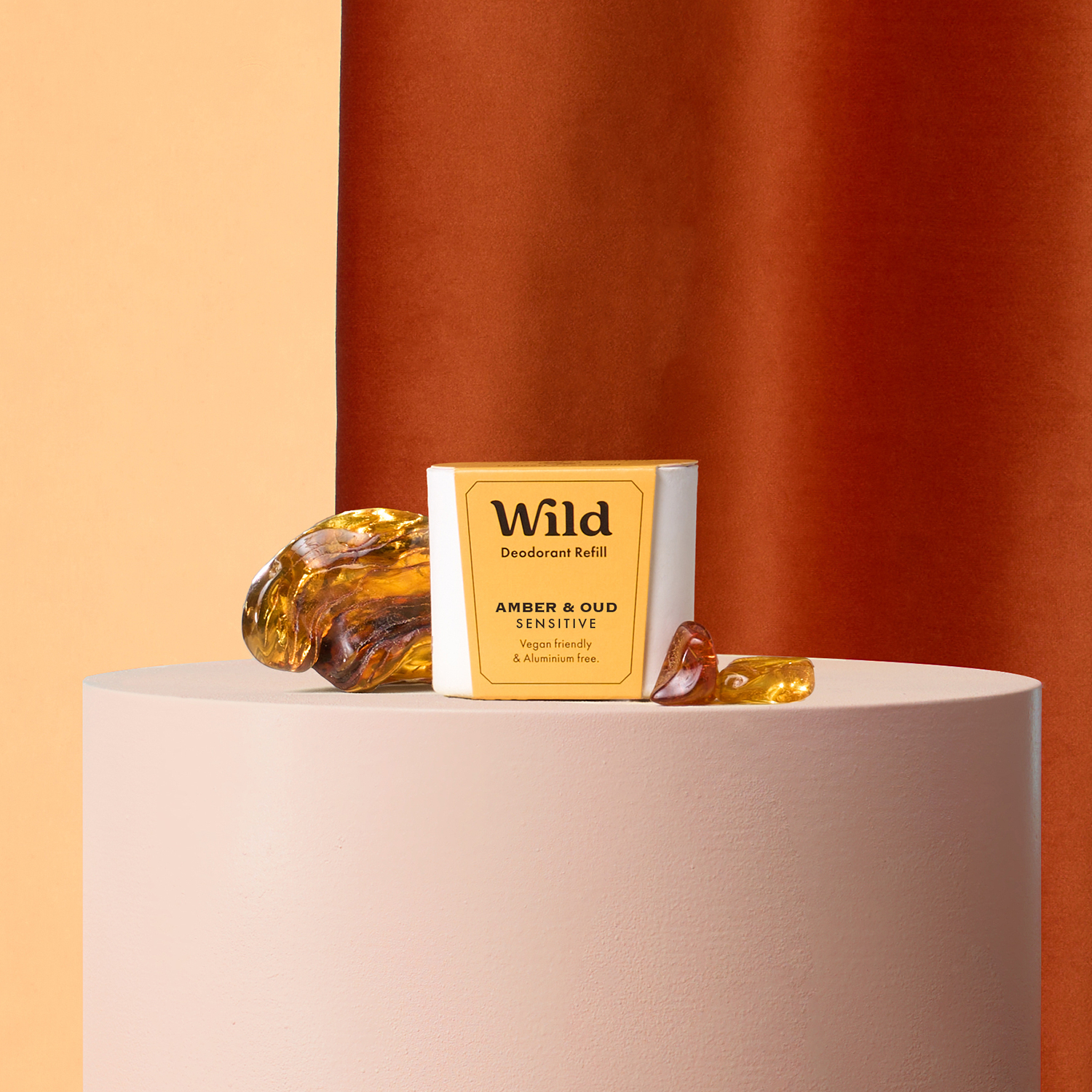 Caption: a bottle of wild on a table next to a bar of soap