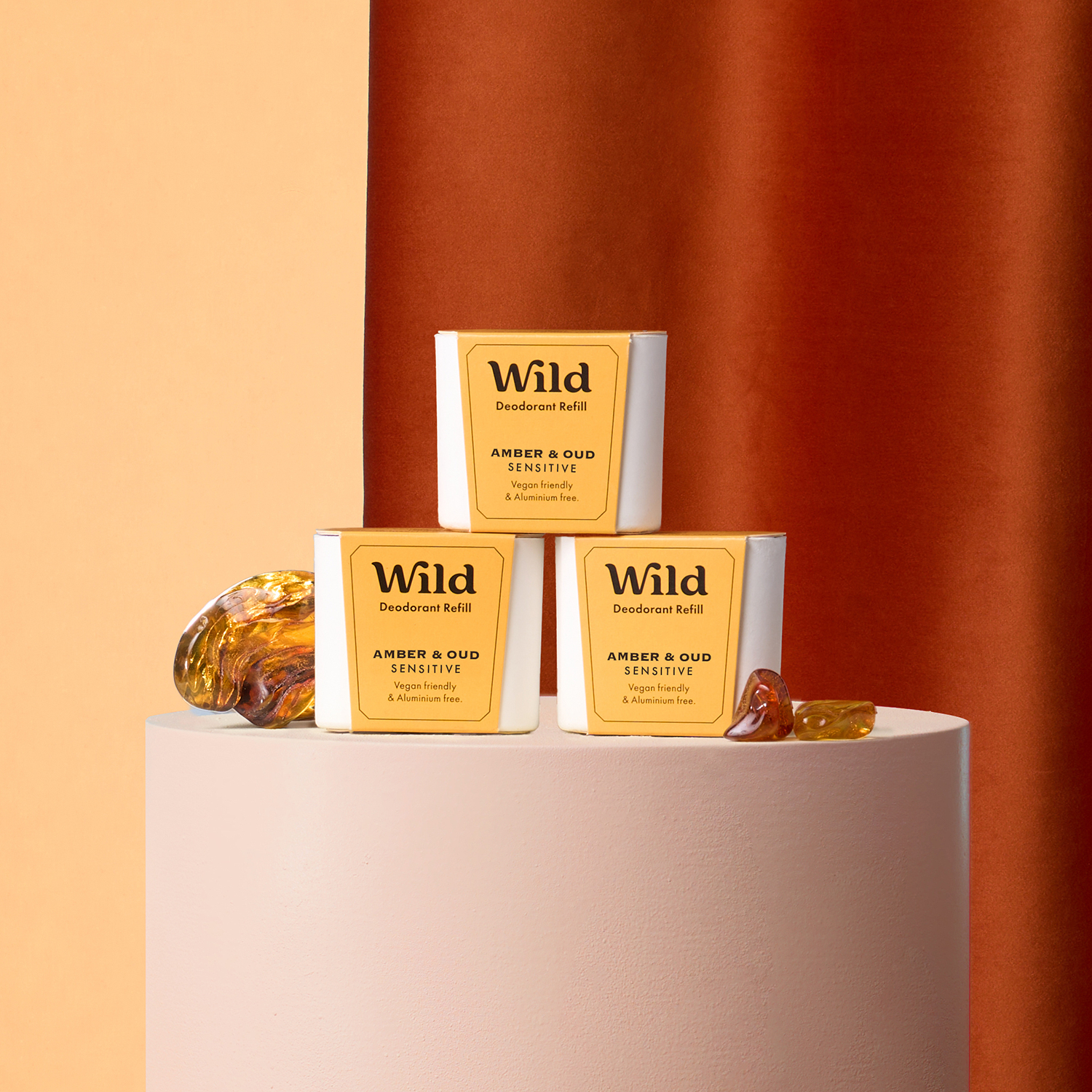 Caption: three boxes of wild honey sitting on top of a white cake