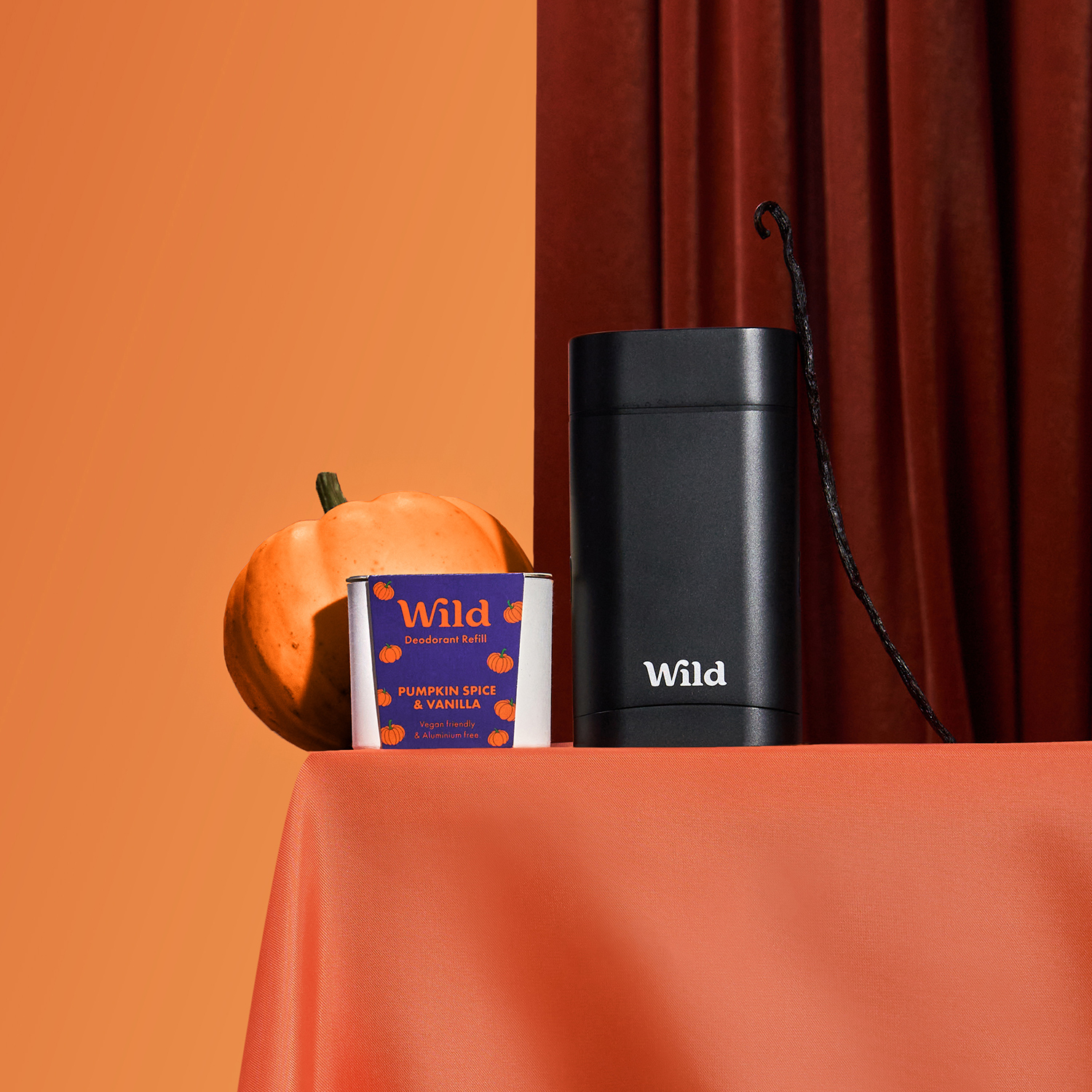 Caption: a bottle of wild next to a book and a pumpkin