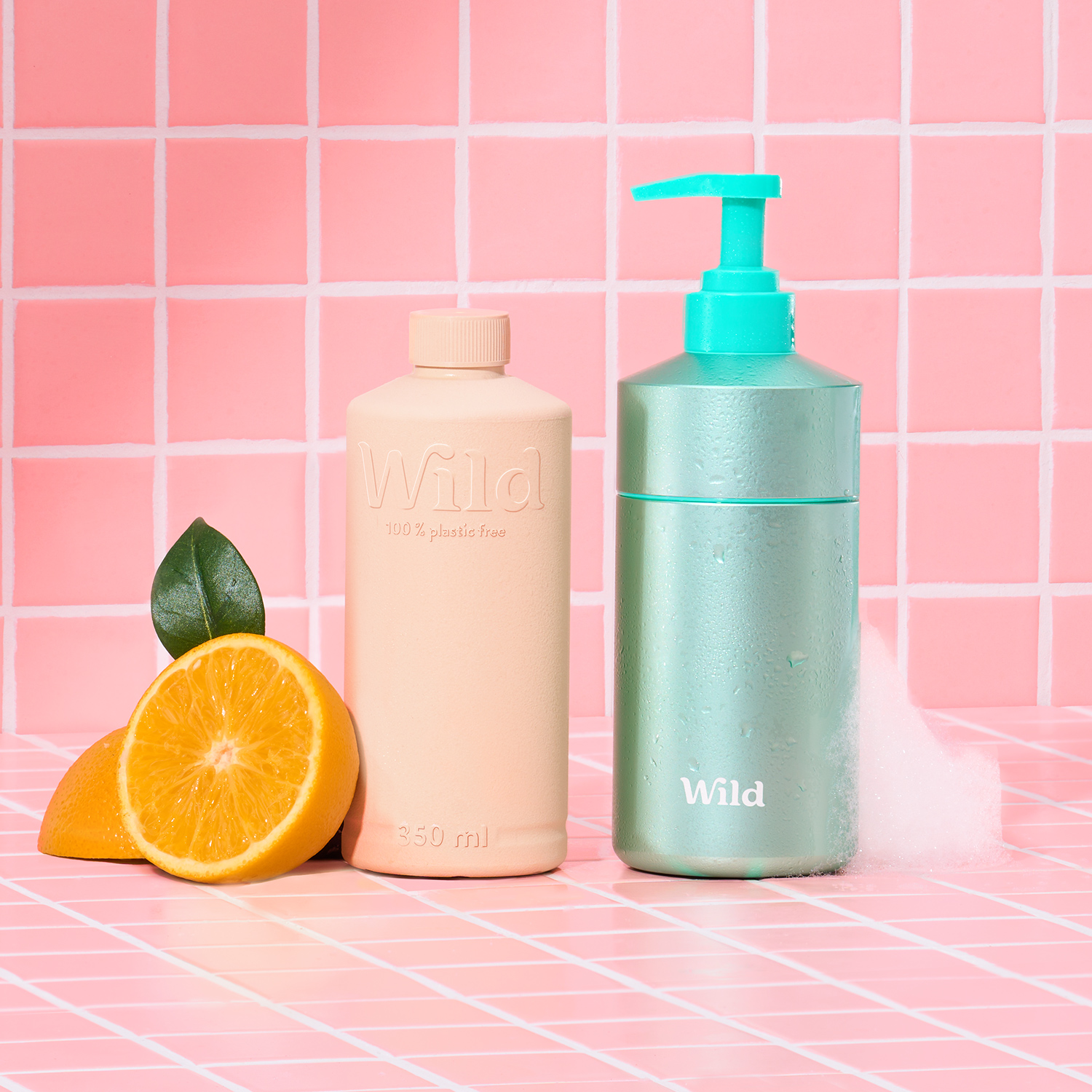 Caption: a bottle of soap next to an orange and a tube of lotion