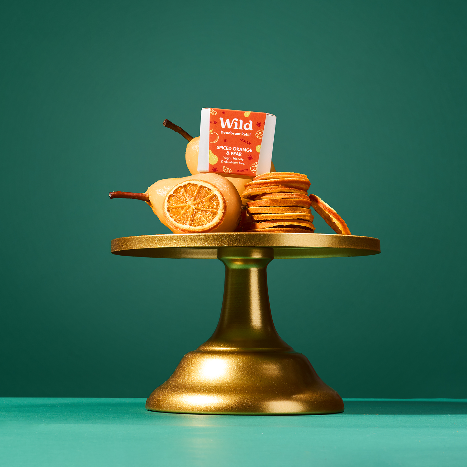 Caption: a gold plate topped with fruit and a packet of wild