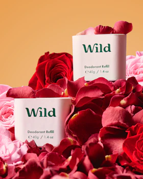 Caption: two boxes of wild deodorant balm surrounded by pink roses