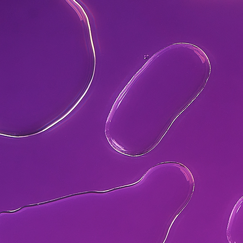 Caption: a close up of a cell phone on a purple surface