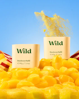 Caption: a pile of yellow candies next to a bottle of wild