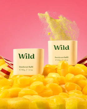 Caption: a pile of yellow candies next to a bottle of wild