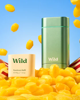Caption: a bottle of wild next to a pile of yellow candies