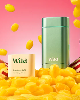 Caption: a bottle of wild next to a pile of yellow candies