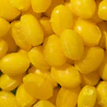 Caption: a close up of a pile of yellow candies
