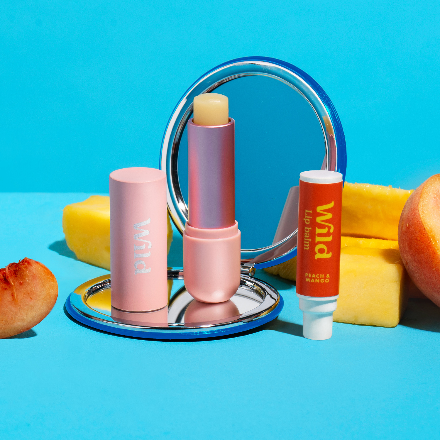 Caption: a blue table topped with a mirror and lipstick