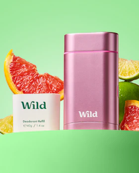 Caption: a bottle of wild deodorant next to grapefruit and grapefr