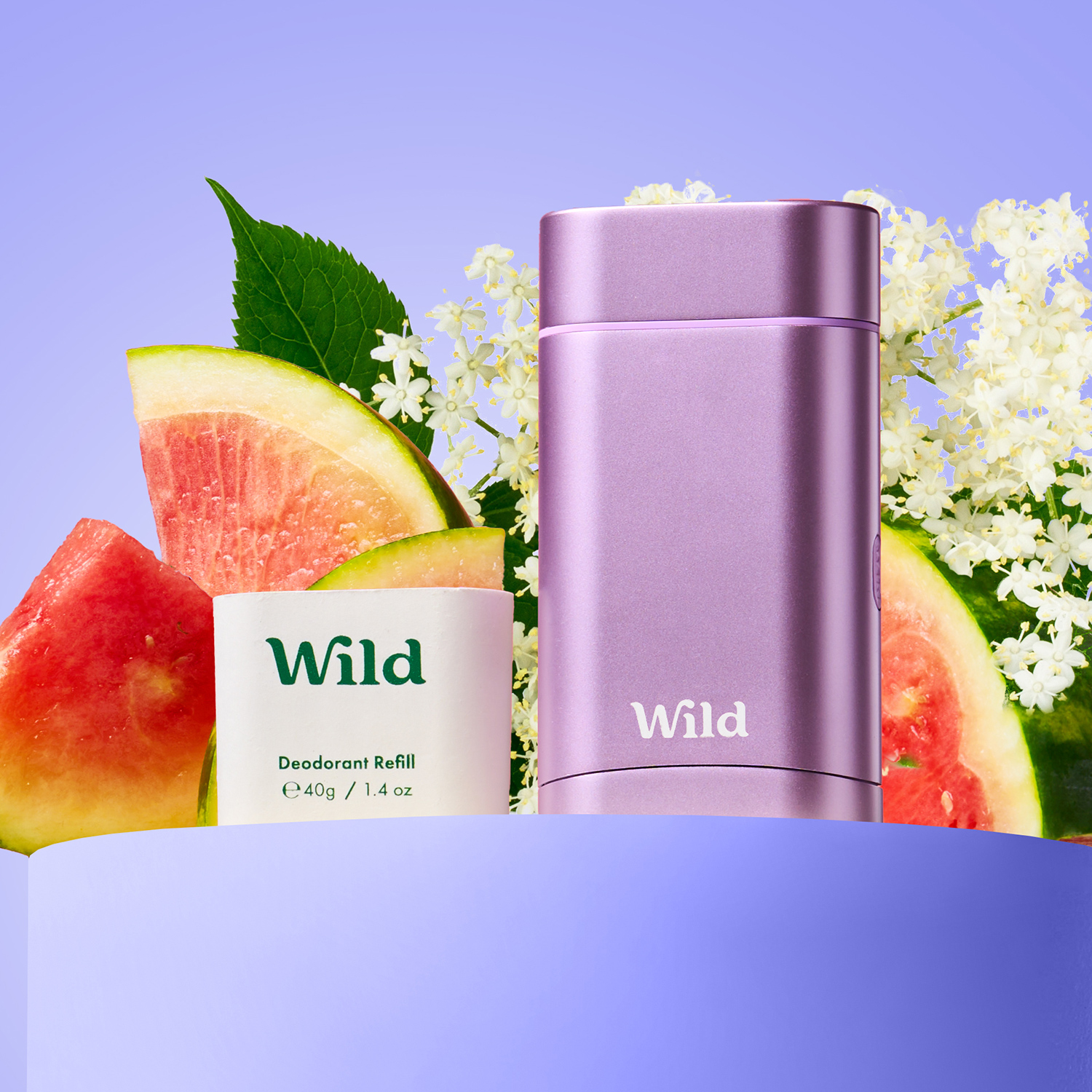 Caption: a bottle of wild next to some fruit and flowers