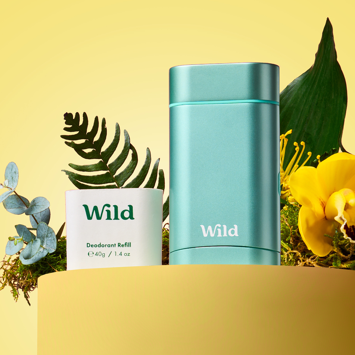 Caption: a bottle of wild deodorant next to a plant