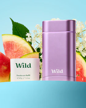 Caption: a bottle of wild next to a bunch of fruit