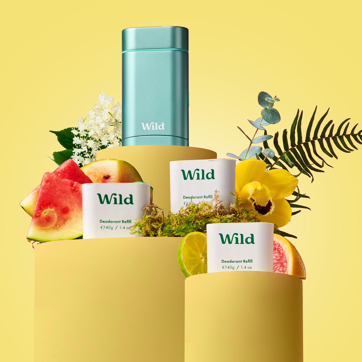 Caption: a bottle of wild is surrounded by fruit and flowers