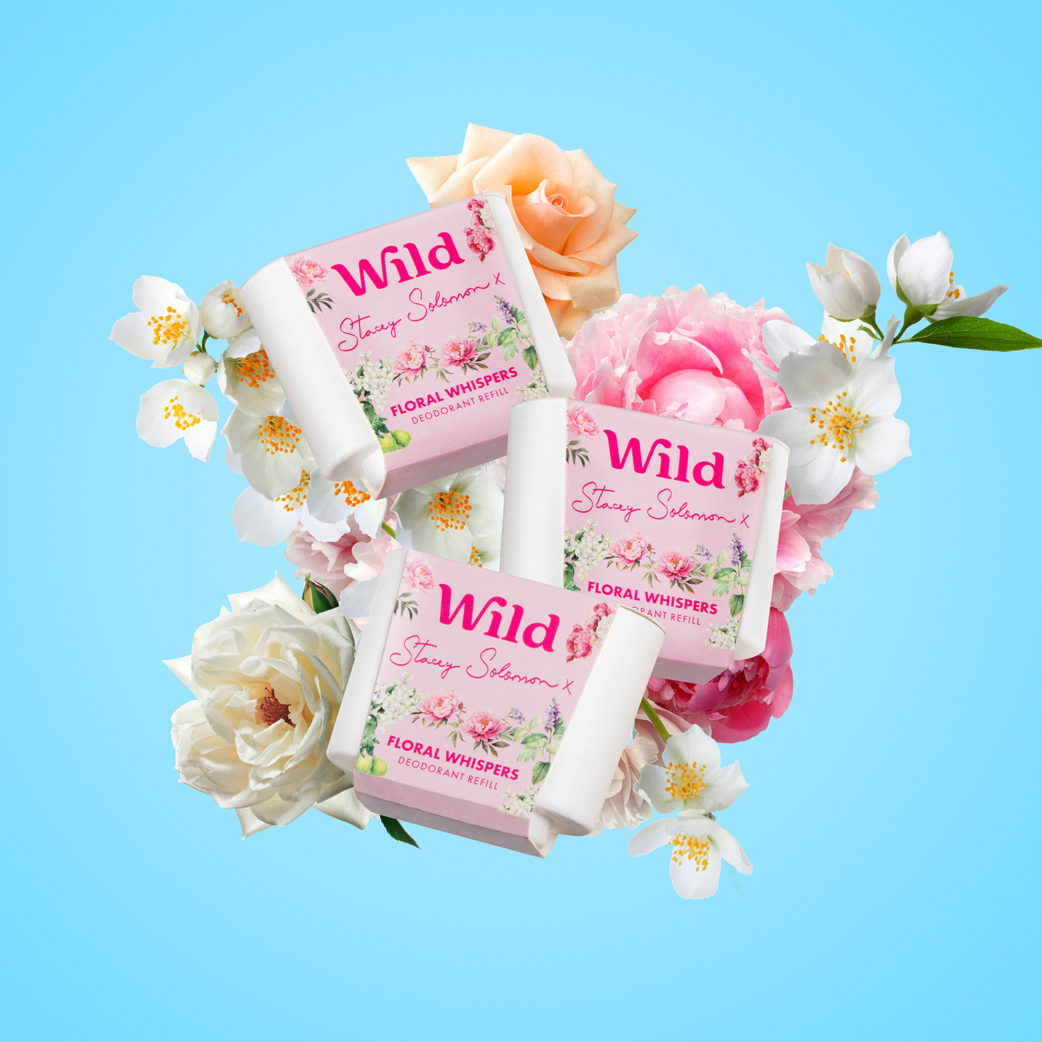 Caption: a couple of soaps sitting on top of a bouquet of flowers