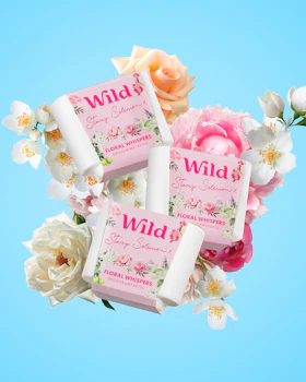Caption: a couple of soaps sitting on top of a bouquet of flowers