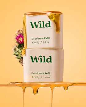 Caption: two containers of wild deodorant sitting on a shelf
